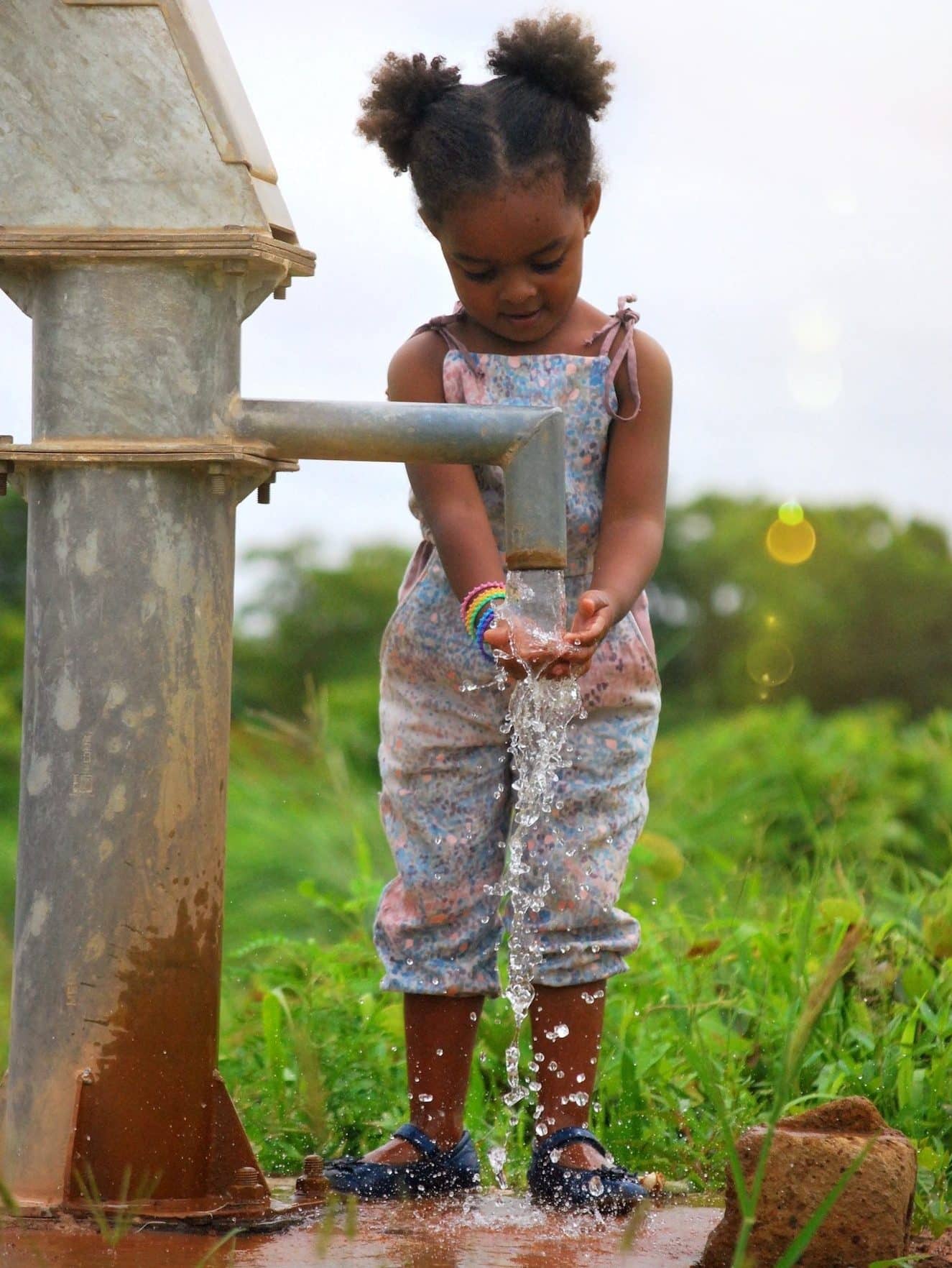 girl-washing-her-hands-at-a-water-well-in-burkina-faso-africa-e1659542851666